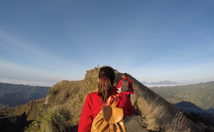 Bali: Mount Batur Sunrise Hike and Hidden Waterfall - Walking the crater and crossing black volcanic ground