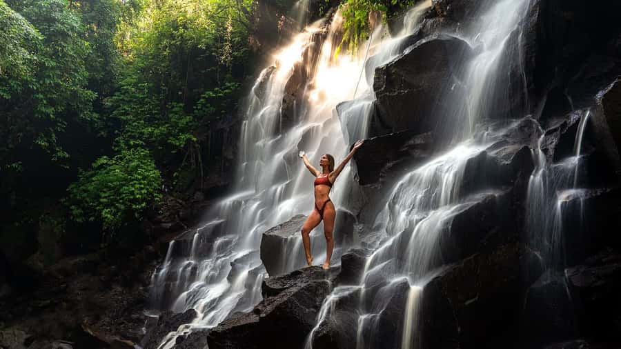 Bali/Ubud: Kanto Lampo Waterfall, Monkey Forest & Swing Tour - Kanto Lampo Waterfall: wet rocks and a cool reward