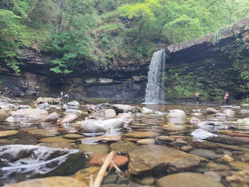 From Cardiff: Guided Hike to 8 Waterfalls in Brecon Beacons - Walking behind the falls